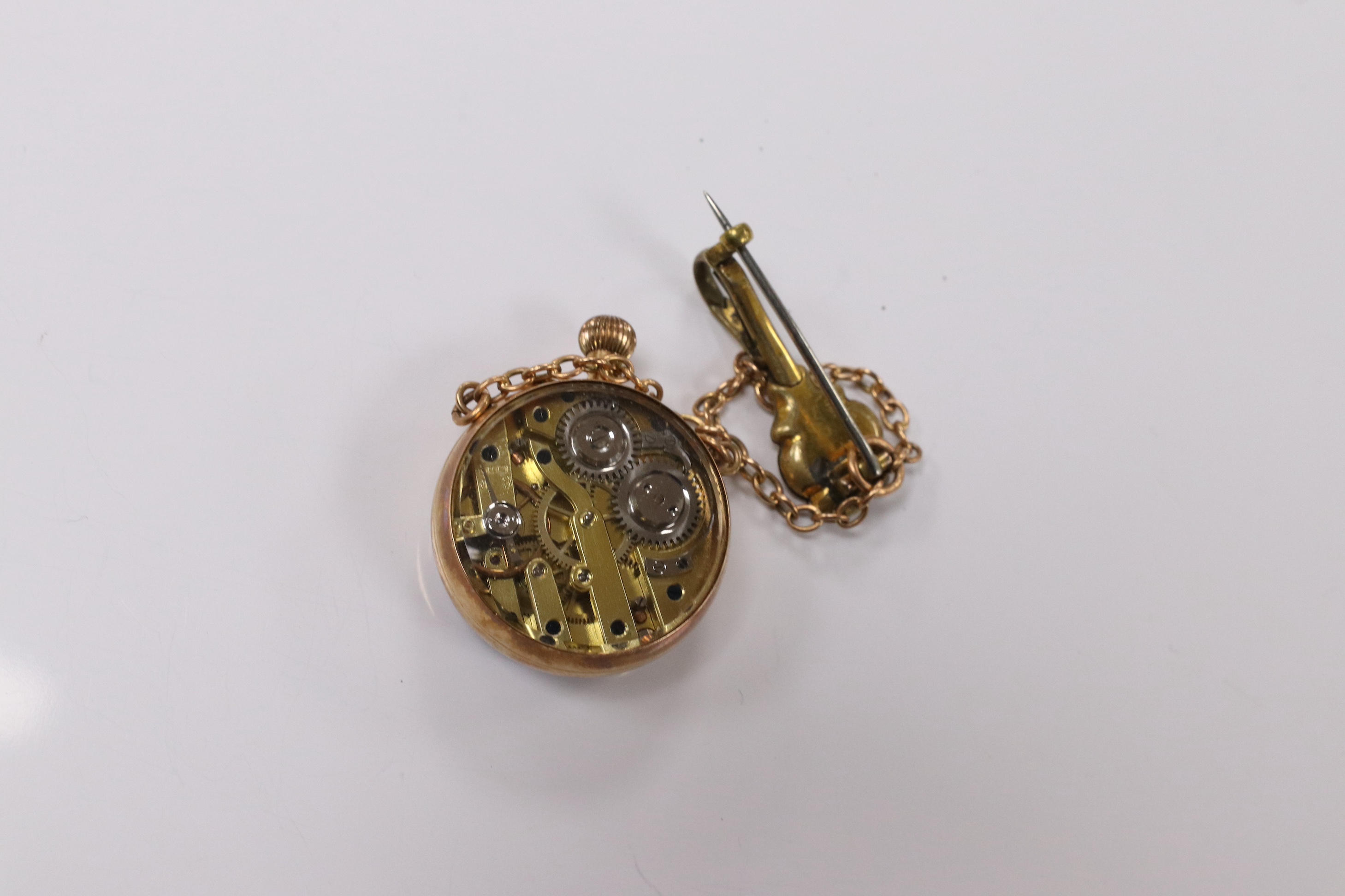 A lady's yellow metal mounted fob watch, with Roman dial and suspension chain with brooch, case diameter 26mm. Condition - fair